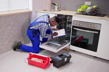 African American Repairman Fixing Dishwasher Appliance