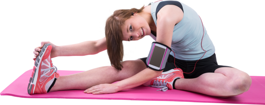 Pretty brunette looking at camera and stretching her leg on exercise mat