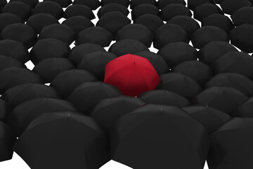 Red umbrella over black umbrellas