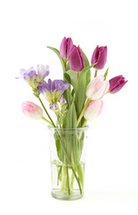 Naklejka na ściany i meble Flowers Tulip and Freesia in vase isolated on white background. Bouquet of purple pink spring flowers.