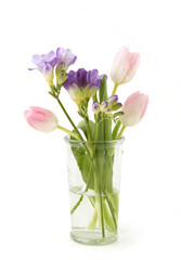 Flowers Tulip and Freesia in vase isolated on white background. Bouquet of purple pink spring flowers.