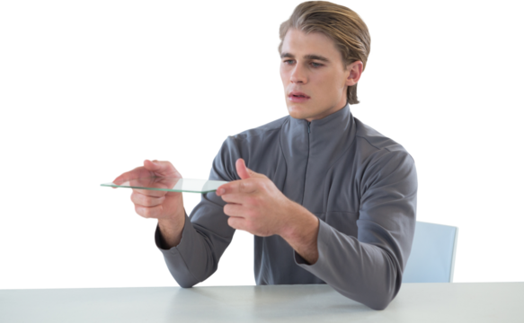 Businessman holding glass interface while sitting at table