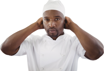 Portrait of chef adjusting hat