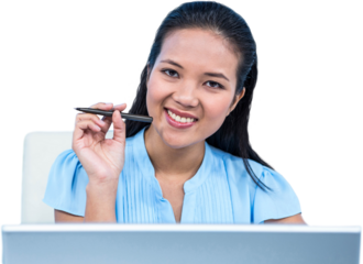 Smiling young businesswoman sitting at her desk