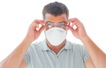 Portrait of man wearing goggles with protective mask