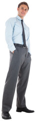 Happy businessman standing with hands in pockets