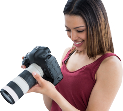 Happy young female photographer looking at digital camera