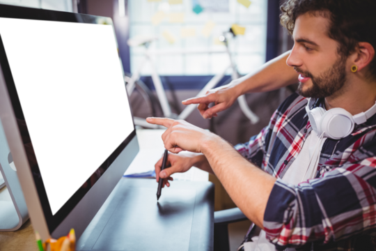 Side view of businessmen pointing on computer monitor