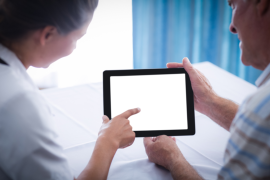 Female doctor and man discussing on digital tablet