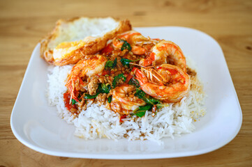 Rice topped with stir-fried prawns and basil leaves with Fried egg ,Thai food