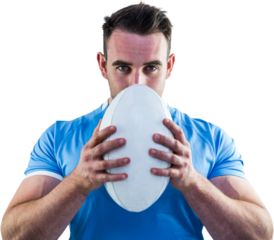 Rugby player looking at camera with ball