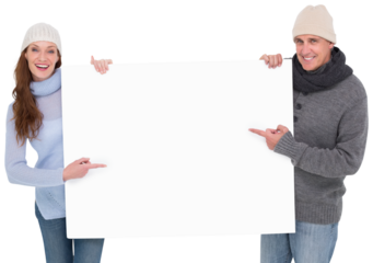 Casual couple in warm clothing holding poster