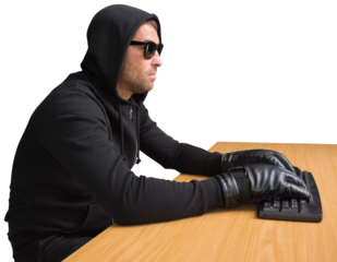 Side view of hacker using computer at desk