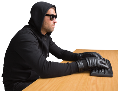 Side view of hacker using computer at desk