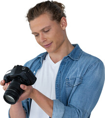 Male photographer looking at digital camera