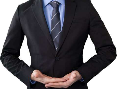 Mid section of businessman in suit while standing with hands cupped
