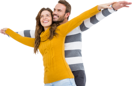 Young couple standing with arms outstretched