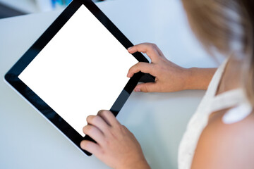 Girl using digital tablet at table