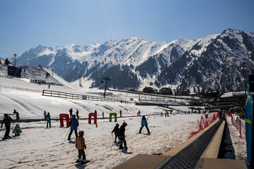 Almaty Kazakhstan 25 March 2023. Medeo Shymbulak Mountain Resort's ski slopee with skiers and...