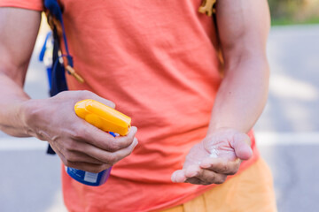 Sunblock bodycare lotion for summertime. Unrecognizable mid man closeup ultraviolet rays protection