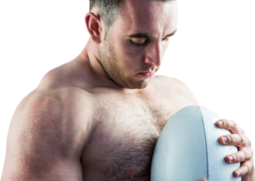 Shirtless rugby player holding ball