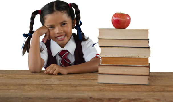 Schoolgirl leaning by books and apple on desk - Powered by Adobe