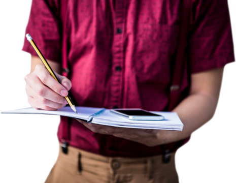 Mid section of student with mobile phone writing on notebook 