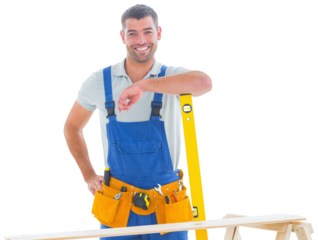 Smiling carpenter in overalls with spirit level
