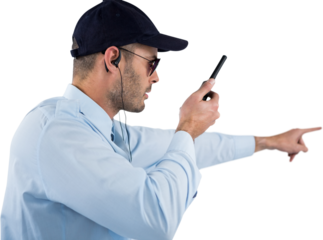 Security officer pointing away while talking on walkie talkie