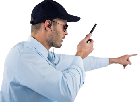Security officer pointing away while talking on walkie talkie - Powered by Adobe