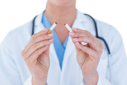  Doctor holding broken cigarette  - Powered by Adobe