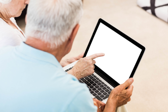 Focused senior couple using laptop - Powered by Adobe