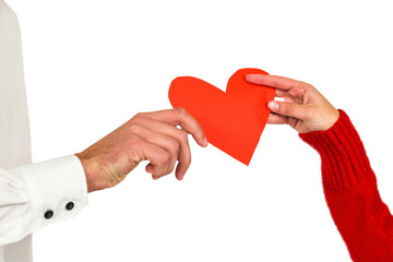 Couple hands holding heart shaped paper