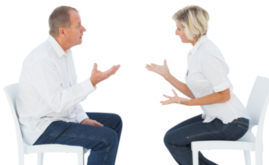Older couple sitting in chairs arguing