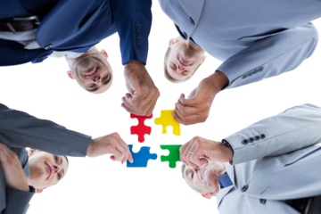 Business colleagues holding piece of puzzle