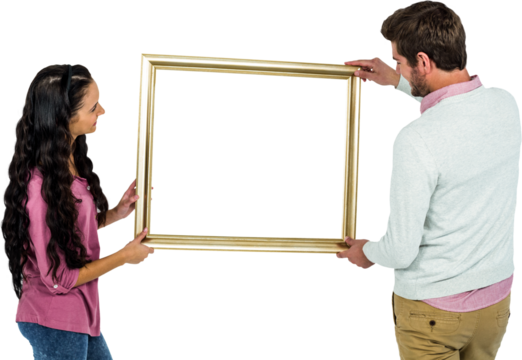 Smiling couple holding picture frame 