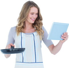 Smiling woman holding frying pan and tablet pc 
