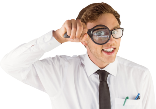 Geeky businessman looking through magnifying glass