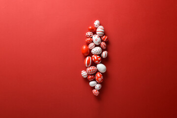 Easter backgrounds, scattered Easter red and white eggs on a bright red background.