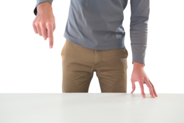 Mid section of creative businessman gesturing while standing at table