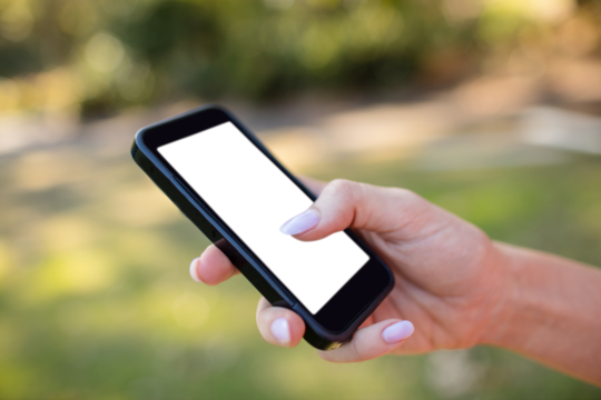 Cropped hands of woman using phone