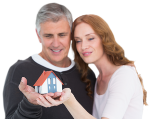 Casual couple holding small house