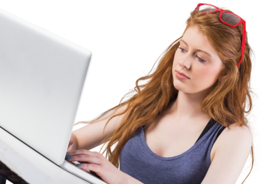 Pretty redhead working on laptop 