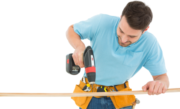 Construction worker using hand drill on wooden plank