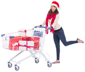 Cute woman in santa hat with shopping trolley