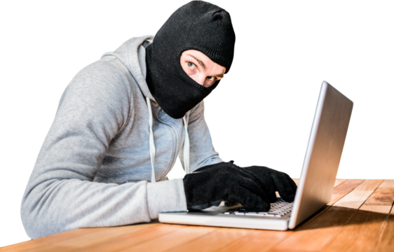 Focused thief with hood typing on laptop