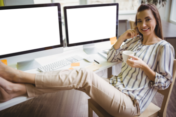 Portrait of woman holding cup while sitting