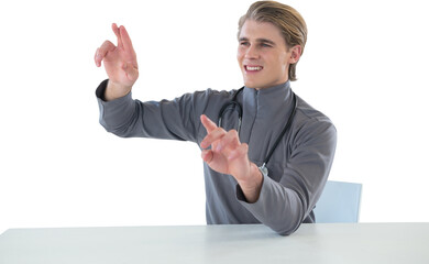 Smiling male doctor touching imaginary interface screen while sitting at table