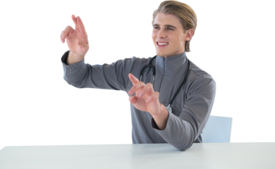 Smiling male doctor touching imaginary interface screen while sitting at table