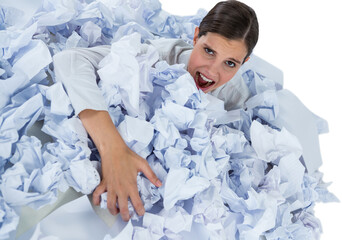 Portrait of unhappy businesswoman in heap crumpled paper